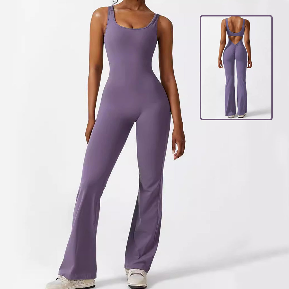 Model wearing a purple sleeveless flare yoga jumpsuit featuring a scoop neckline and a supportive bodycon fit with flared leg pants